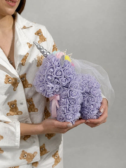 Lavender rose unicorn gift cradled horizontally with soft teddy pyjamas