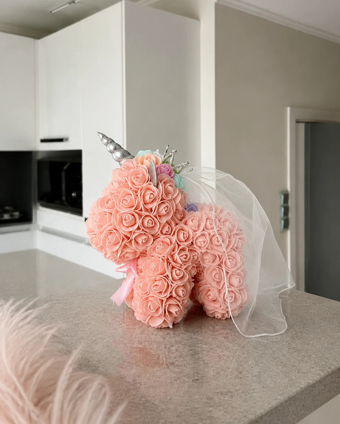 Peach rose unicorn keepsake displayed on a natural kitchen counter