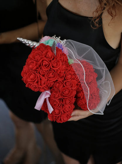 Red rose unicorn keepsake held against a black dress